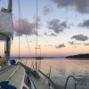 Sailboat motoring at dawn