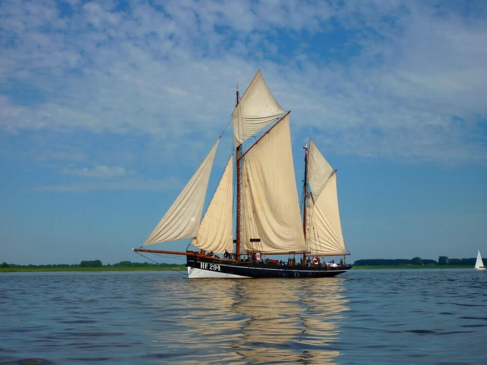 Ketch in soft afternoon sun with clouds