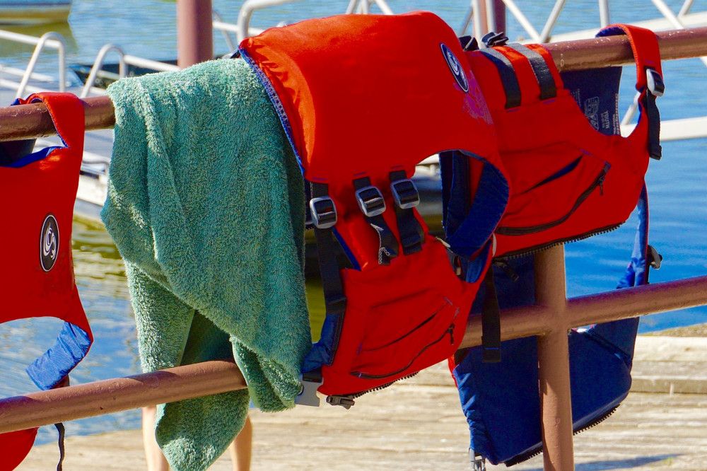 Sailing safety gear hanging from rail on boat