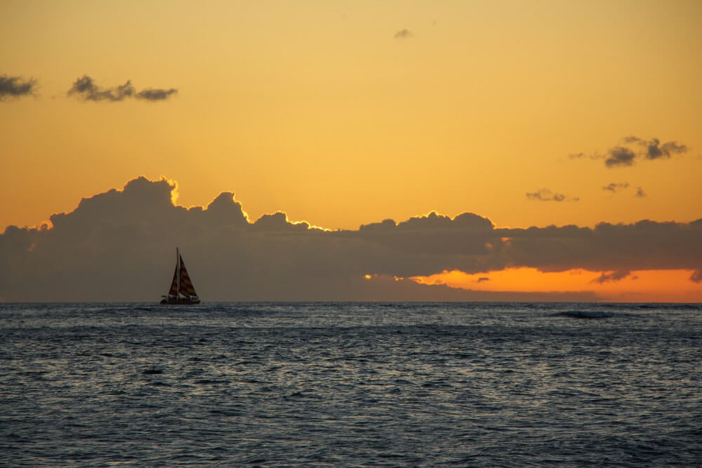 Sailboat at dusk in open water