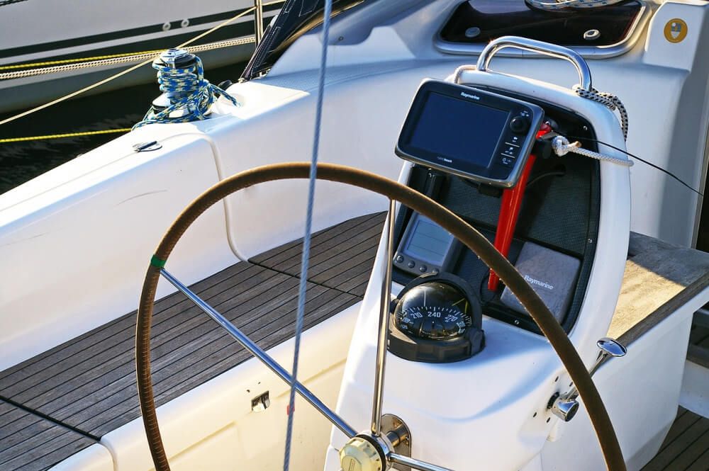 Chartplotter and compass at wheel of the boat