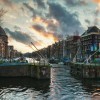 Canal lock in city of Amsterdam with old buildings