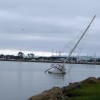 Sailboat half sunk under grey sky