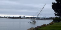 Sailboat half sunk under grey sky