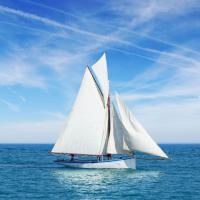 Beautiful white gaff-rigged cutter with gaff top sail and two staysails
