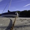 Sailboat with anchor chain in sand