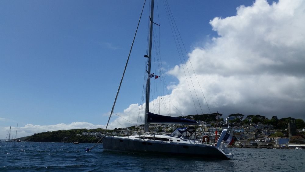 OVNI aluminum sailboat at anchor in calm bay