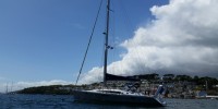OVNI aluminum sailboat at anchor in calm bay