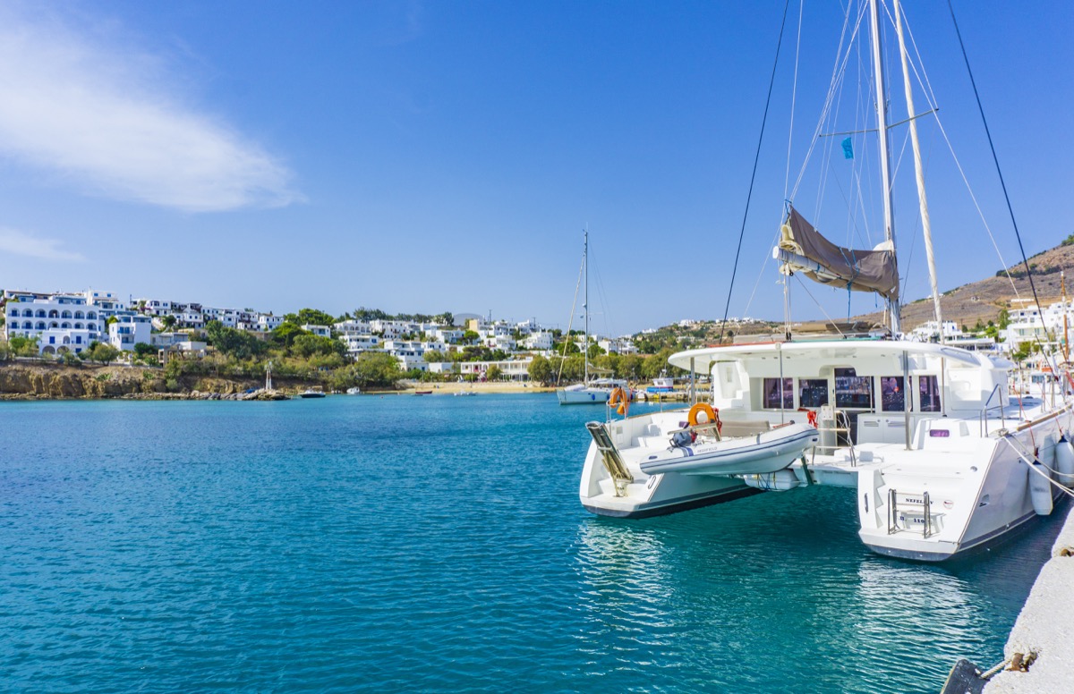 Cruising catamaran at dock in blue waters