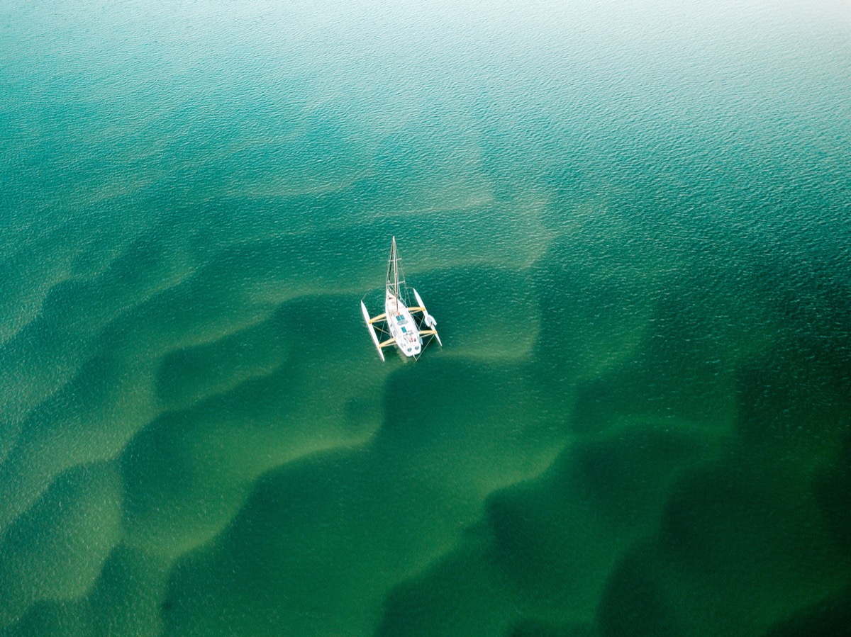 Trimaran in green-blue waves