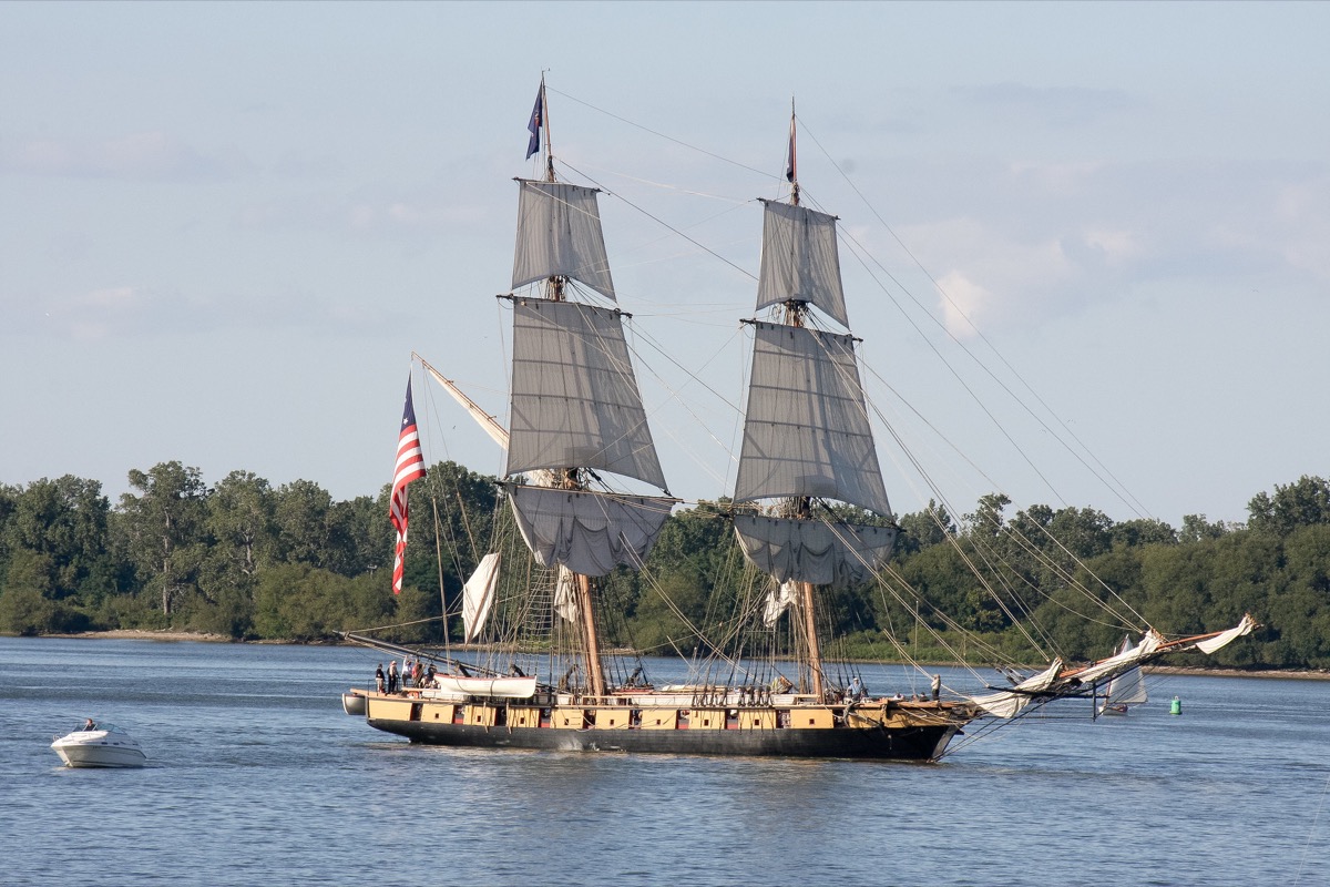 Brig under sail with woodlands