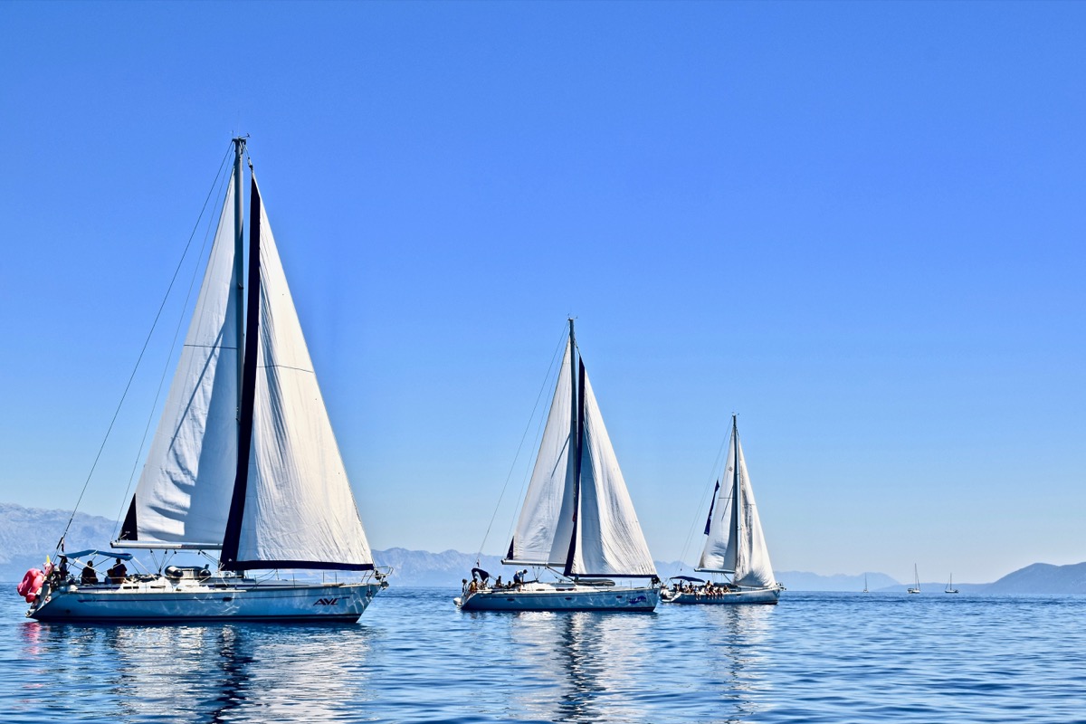 Three Bermuda Sloops in bright blue water