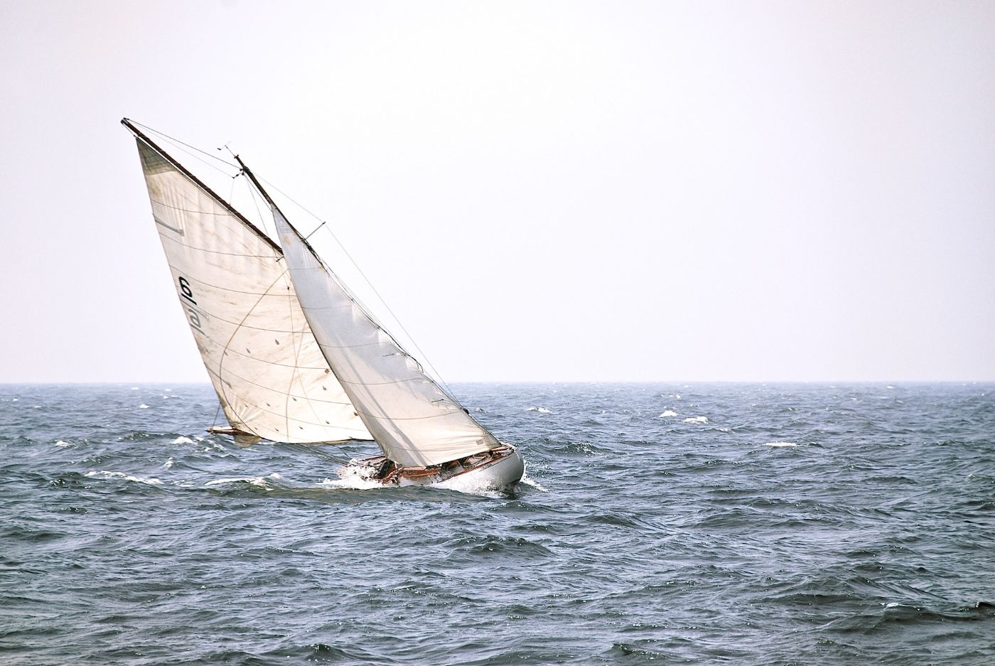 the small sailboat careened in the rough sea