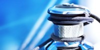 Steel self-taling sailboat winch on blue background