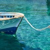 Small boat in blue water of marina