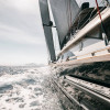 Bow shot of black wooden cruising sailboat