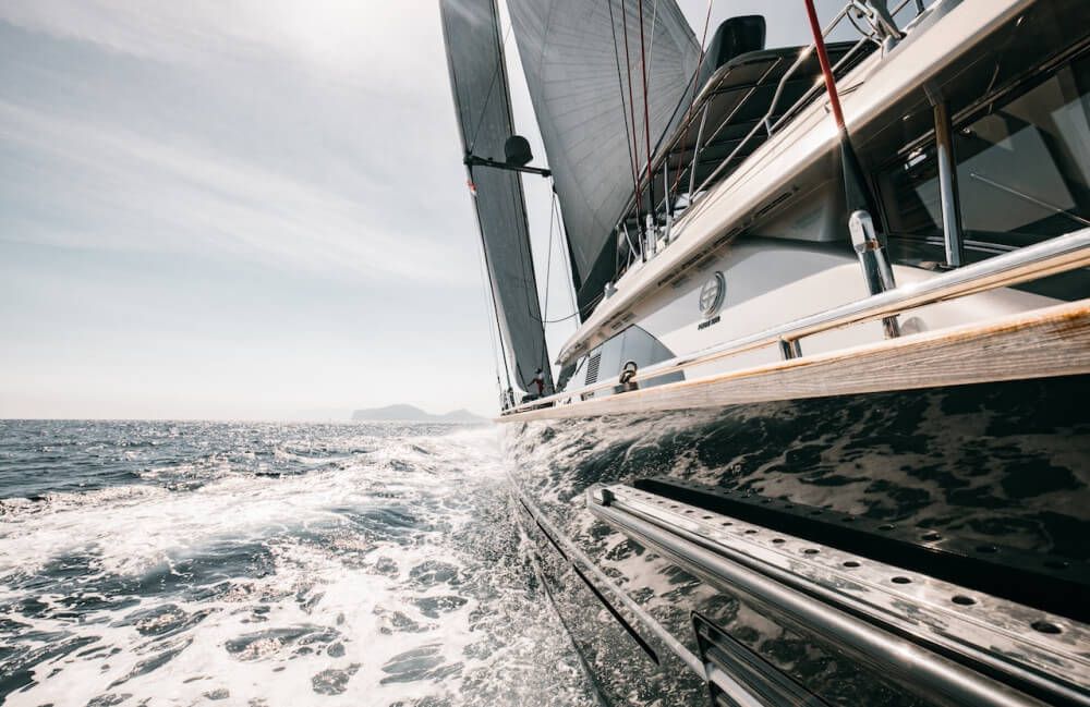 Bow shot of black wooden cruising sailboat