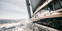 Bow shot of black wooden cruising sailboat