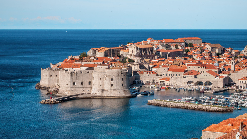 The old stone city walls of Dubrovnik, which are in the water