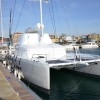 Catamaran at dock in white shrink wrap